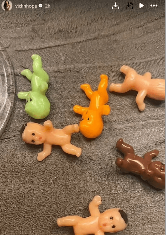 Several small plastic baby dolls lying on a surface.