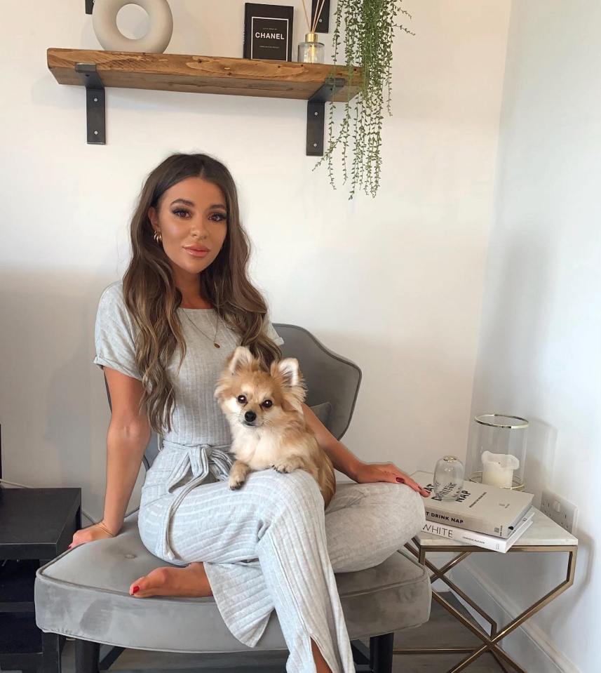 Woman sitting in a chair with her small dog.