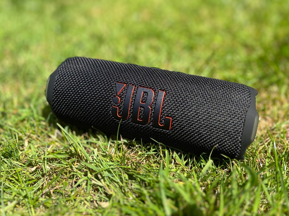 JBL Flip 7 portable speaker on the grass.
