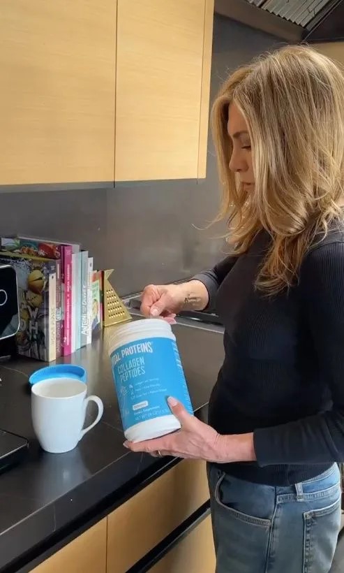 Jennifer Aniston holding a container of collagen peptides.
