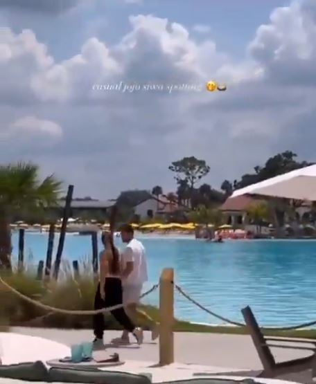 JoJo Siwa and Chris Hughes holding hands at Disney World.