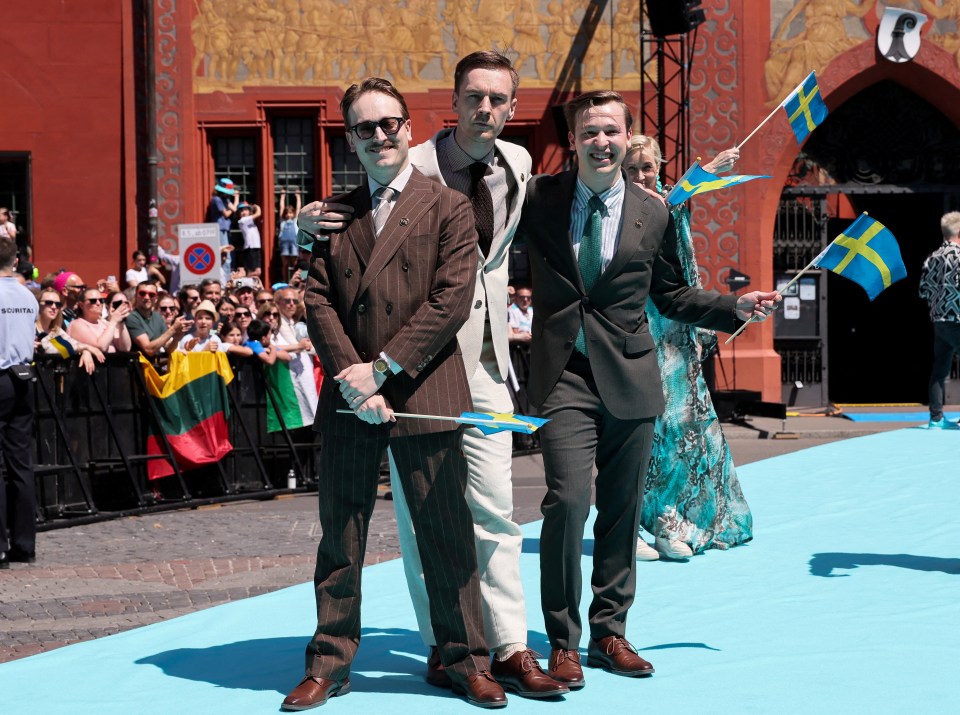 Three men representing Sweden at the Eurovision Song Contest's Turquoise Carpet ceremony.