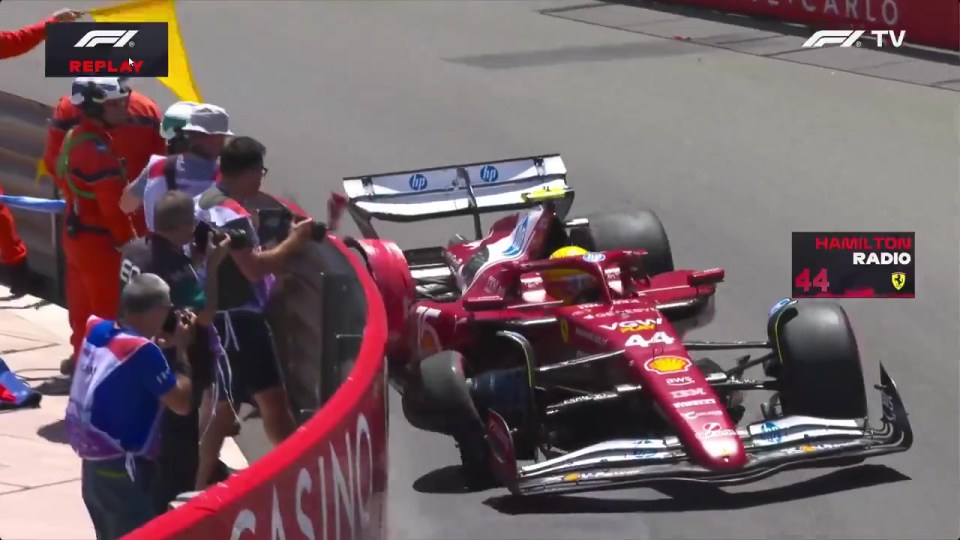 Race car driver being assisted by marshals.