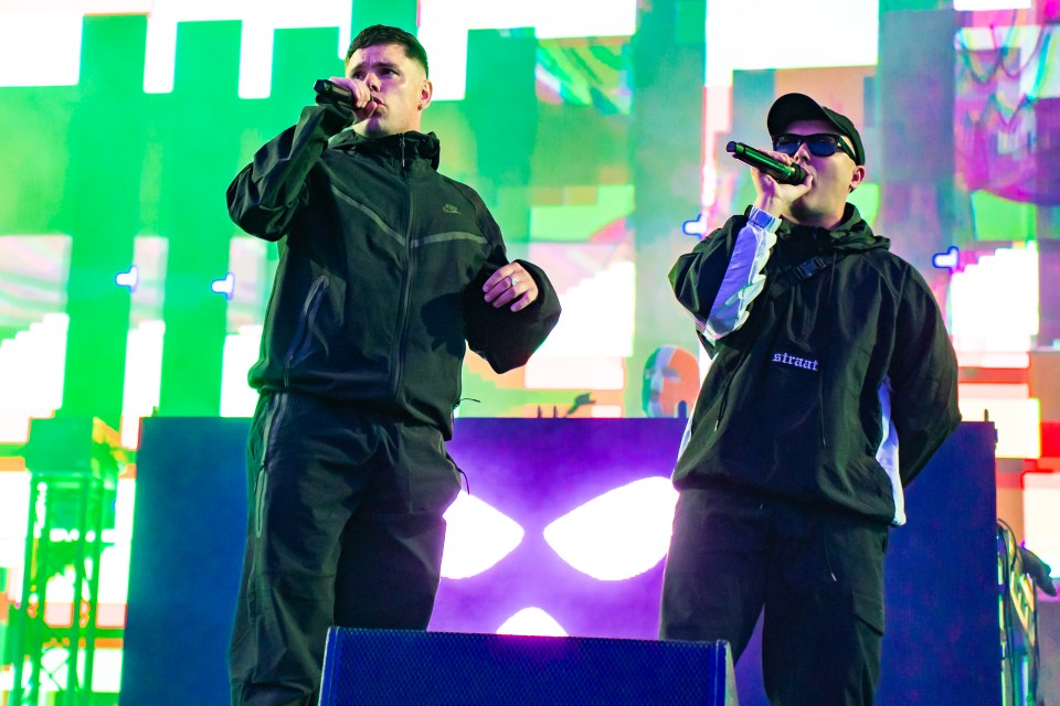Móglaí Bap and Mo Chara of Kneecap performing at a music festival.