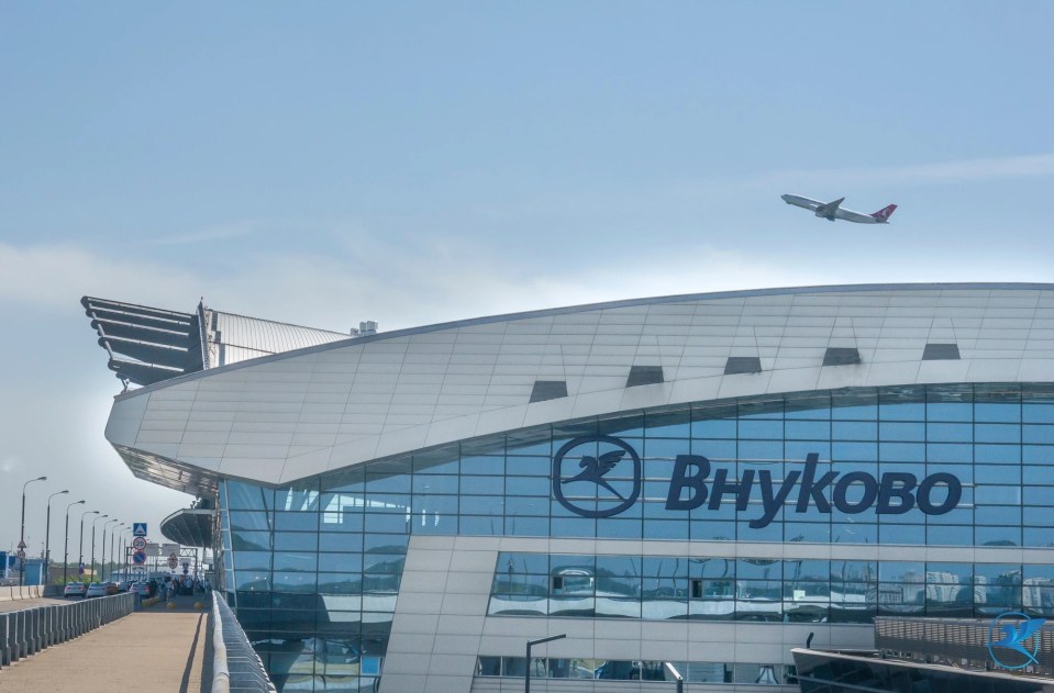 Vnukovo airport in Moscow with a plane taking off.