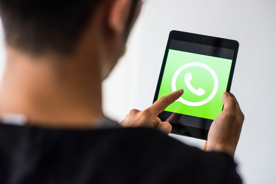 Person using WhatsApp on an iPad.