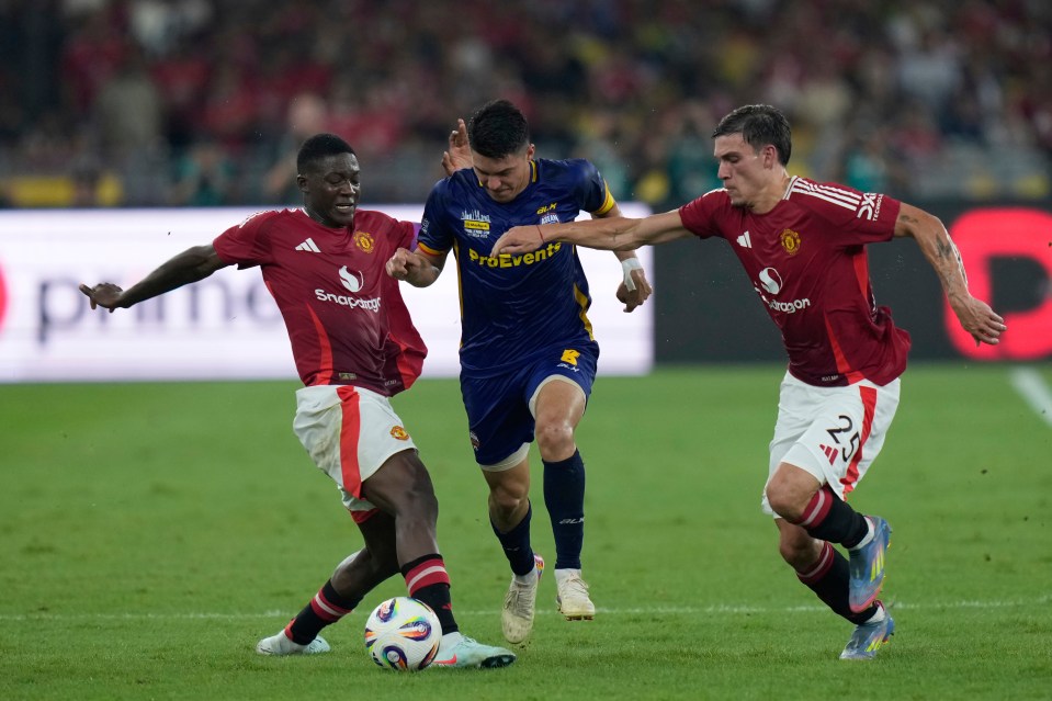 Manchester United's Kobbie Mainoo vying for the ball during a soccer match.