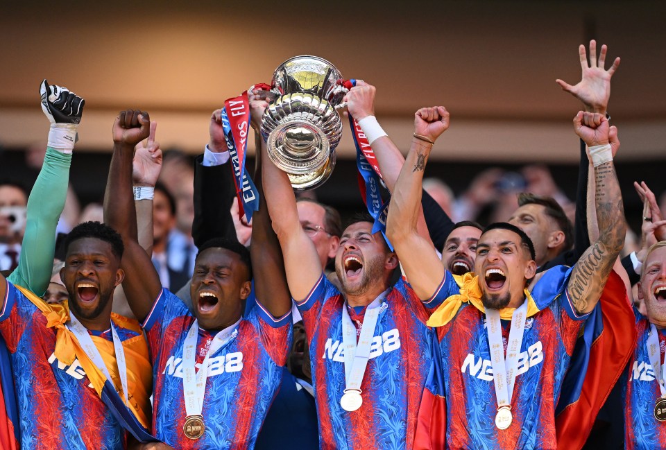 Crystal Palace players celebrating with the FA Cup trophy.