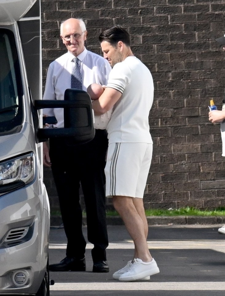 Mark Wright holding his baby daughter.
