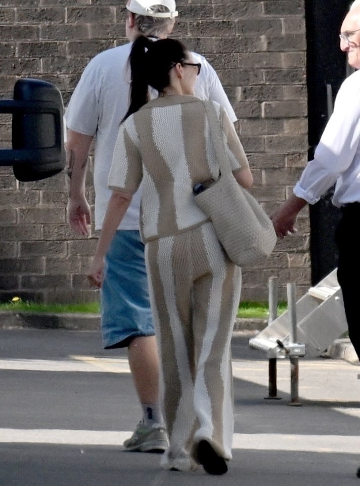 Michelle Keegan walking on a film set.