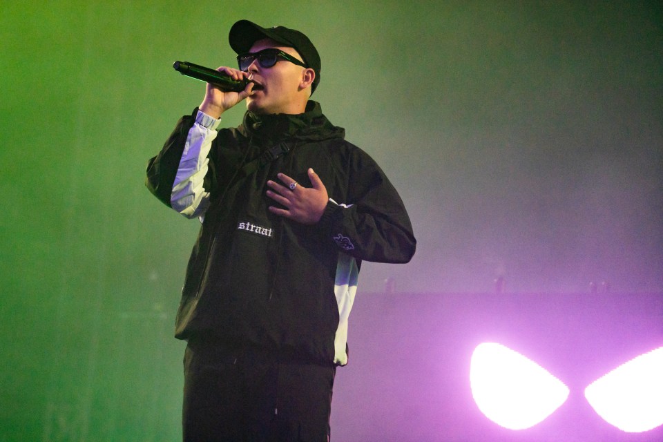 Mo Chara of Kneecap performing at a music festival.