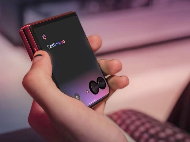 A hand holding a Motorola Razr 60 Ultra phone displaying "Catch me up".