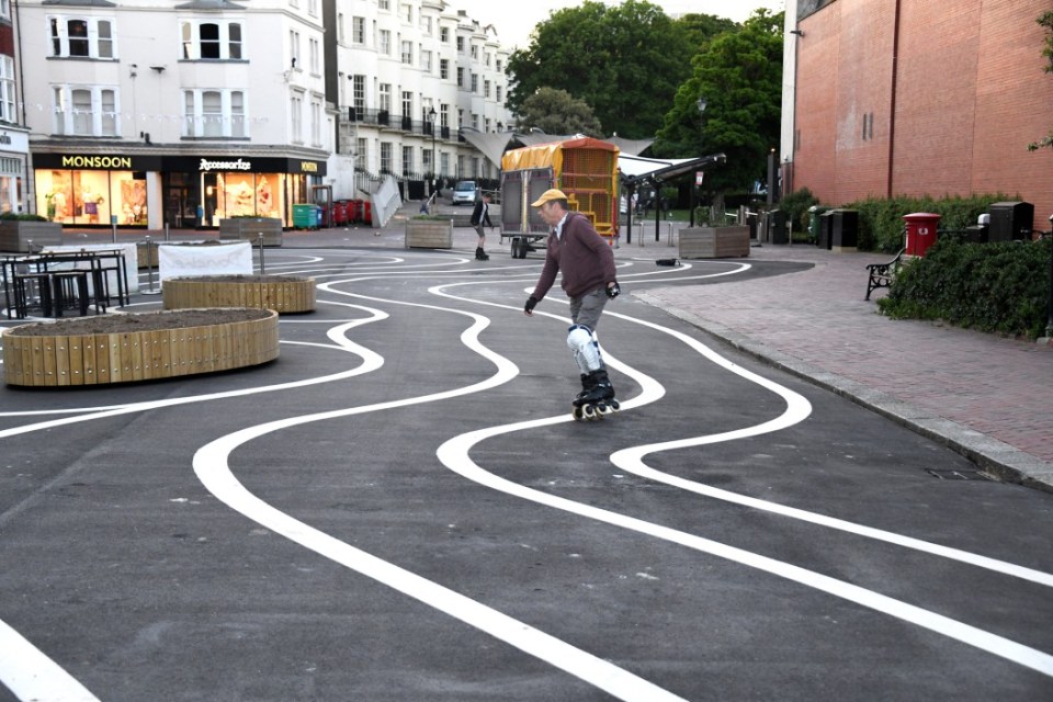 A newly pedestrianised zone has been branded a waste of money with a silly design at a huge cost to the taxpayer along Montague Place in Worthing, West Sussex. Wiggly white lines were added to the new tarmac surface which has cost ¿178,000 as part of an improvement scheme, of which ¿23,500 was spent on design and management fees and ¿1,230 on the painting of the swirly white lines. The Worthing Society Committee were dismayed to see the appearance of the 'swirly' white lines and urged the council to remove the harsh, intrusive white lines as soon as practically possible. Writing on Facebook Sue Belton Worthing Society Chair added, 'This area is part of the historic South Street Conservation Area and should showcase the town linking Montague Street to the seafront promenade. In our opinion these extensive white lines are over-dominant. They detract from the historic character of the listed buildings' Previously the road was used as parking for the disabled for a very short walk to the shops. Now tarmacked, the area has allowed cafe's and restaurants to have more outdoor seating, along with new wooden planters which are yet to have flowers and shrubs planted. People took to Facebook to give their views, Tamara Murray wrote 'Huge shame, waste of money and silly design. By taking away the safe disabled parking there it will take away business from Worthing.' Andrea Bristow added, 'It looks like a kid has been let loose with a white line machine! What an absolute mess.' 'Looks tacky and a terrible waste of money' wrote another mystified resident. Roy Hammond saw the funny side writing, 'I think this is very thoughtful of the council. It's an effort towards all the drunks in Worthing to make them think they are walking in straight lines.' Following a freedom of information request to Adur & Worthing Council, they responded with the costings, 'The pedestrianisation of Montague Place has cost ¿178,000, of which ¿23,500 was full technical scheme design and management fees. This was fully funded by the high street grants provided by the government to the Borough Council in response to the re-opening of the high street following the lifting of restrictions. The costs of the decorative white lining were ¿1,230, which included the cost of material and installation. These costs are included in the overall cost envelope above.' Please credit: Paul Jacobs/pictureexclusive.com Standard reproduction rates apply, contact Paul Jacobs, Picture Exclusive to arrange payment - 07923 866166, pictureexclusive@gmail.com