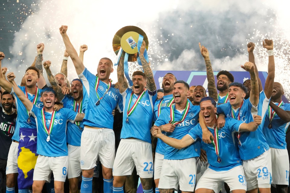 Napoli soccer players celebrating with the Serie A trophy.