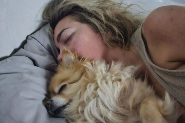 An image collage containing 1 images, Image 1 shows Woman sleeping with her dog