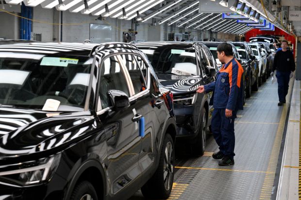 An image collage containing 1 images, Image 1 shows Workers inspecting cars on a Volvo production line