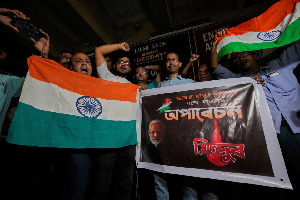 People holding Indian flags and a banner celebrating Operation Sindoor.