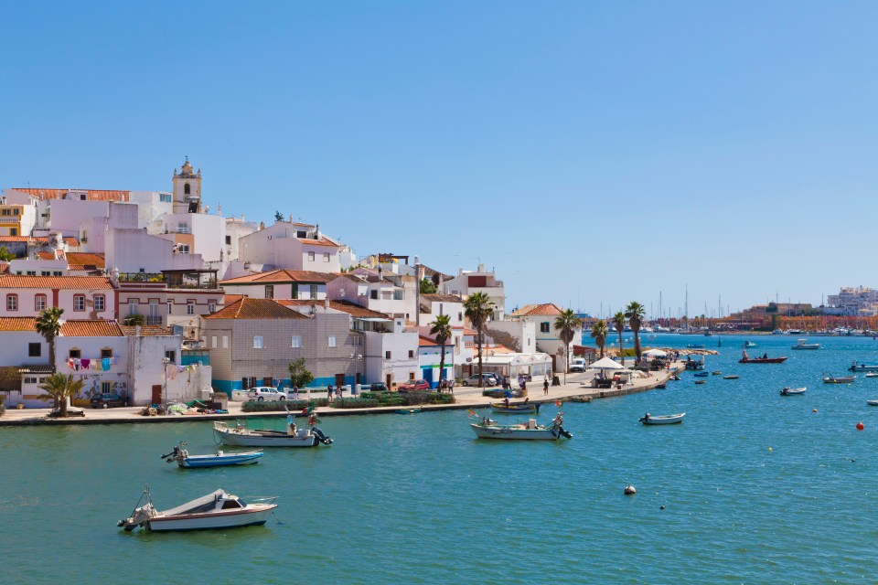 Fishing boats moored in a harbor near Portimao, Portugal.