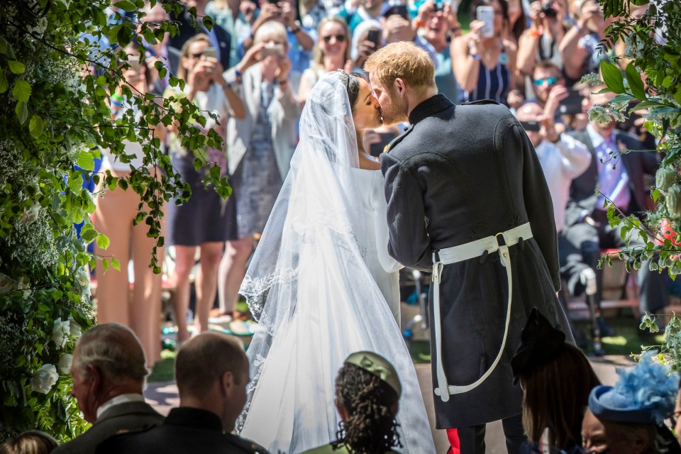 Prince Harry and Meghan Markle kissing after their wedding ceremony.