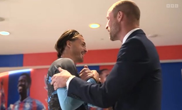 Prince William shaking hands with a man.