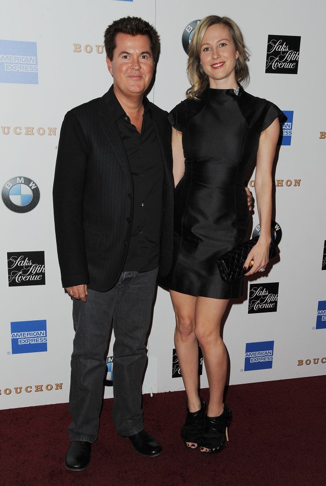 Simon Fuller and his wife at a restaurant grand opening.
