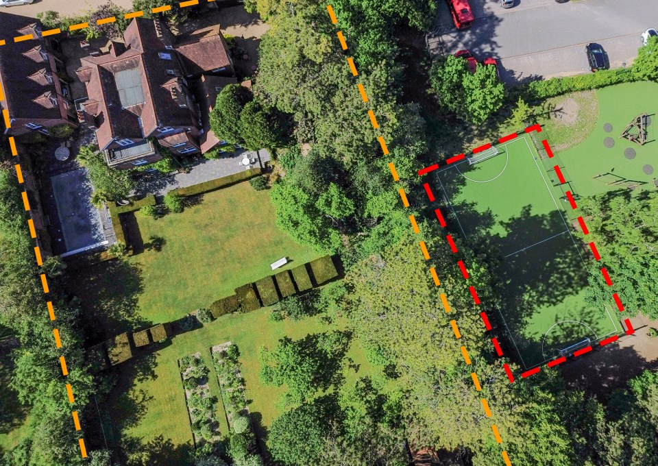 Aerial view of a house and garden next to a playing field.