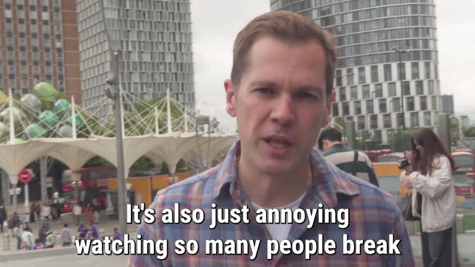 Man speaking in front of city buildings; text overlay reads: "It's also just annoying watching so many people break"