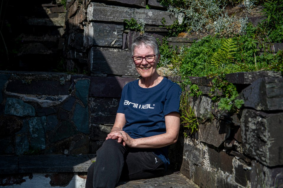 Ronna Halsall, author, sitting in her garden near Dinorwig Quarry.
