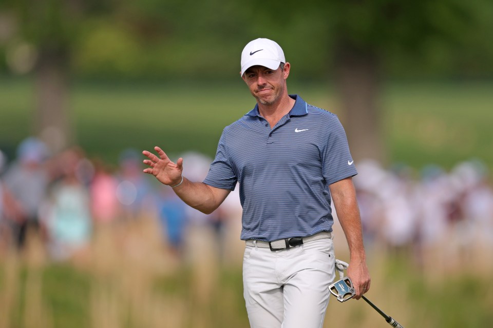 Rory McIlroy acknowledging the crowd during a golf tournament.