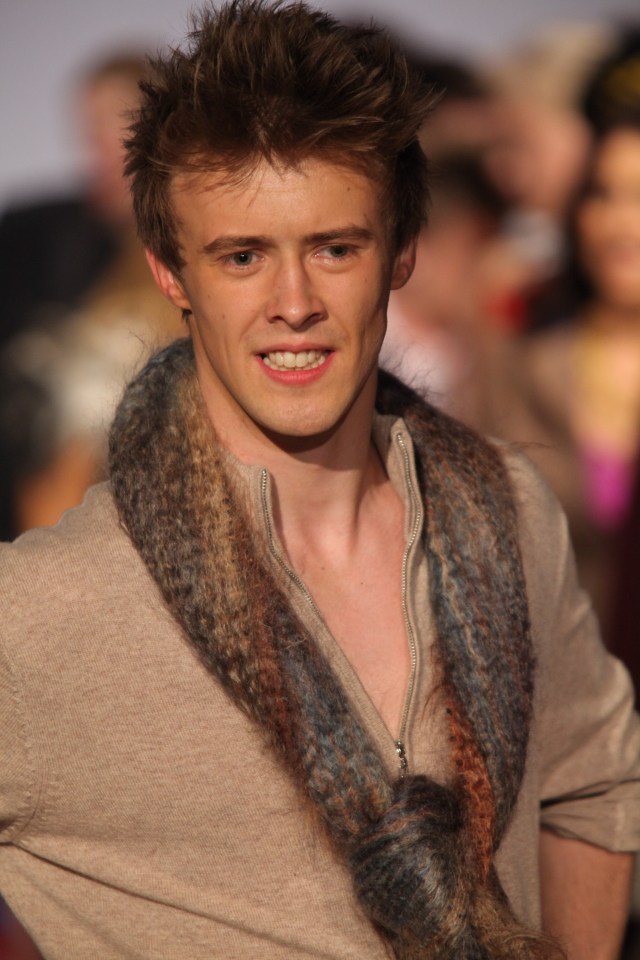 Ruari Cannon walking a runway at a fashion show.