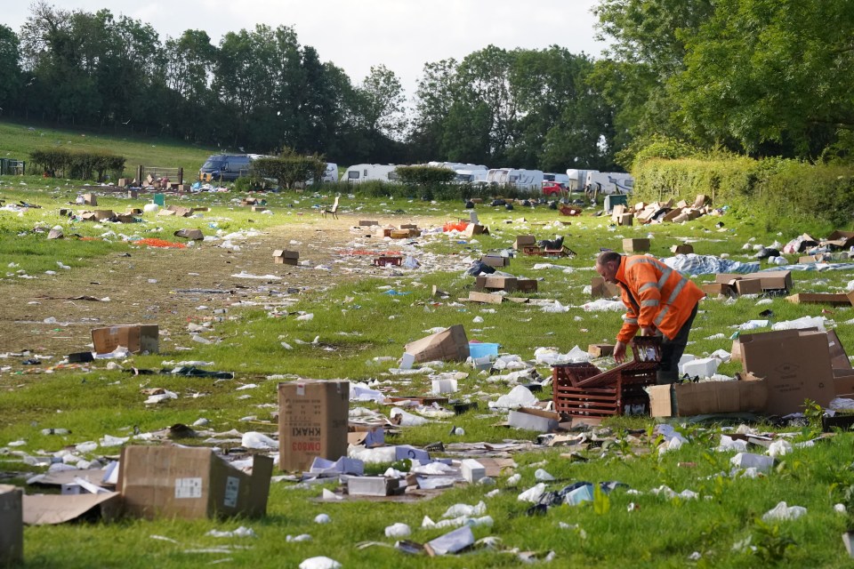 A person cleans up rubbish in a field after the Appleby Horse Fair.