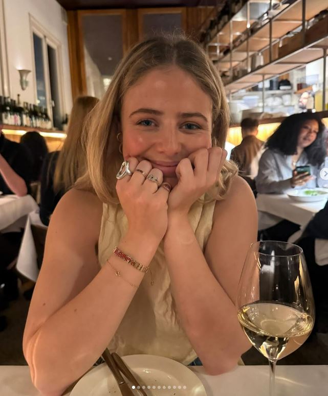 Woman smiling at a restaurant table.