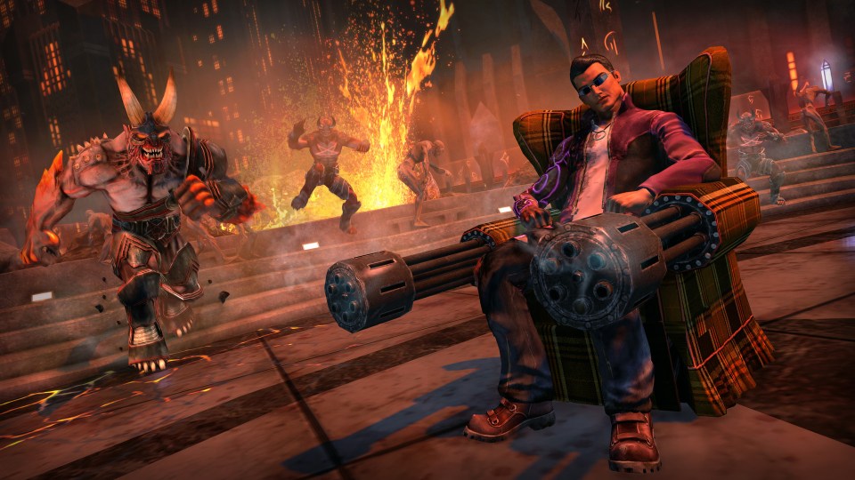 Saints Row video game screenshot: a man sits in a chair holding a large gun, surrounded by demons.