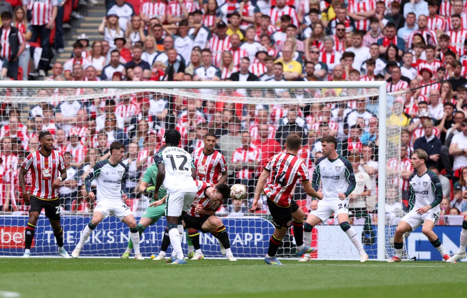 Sheffield United player scoring a goal during a soccer match.