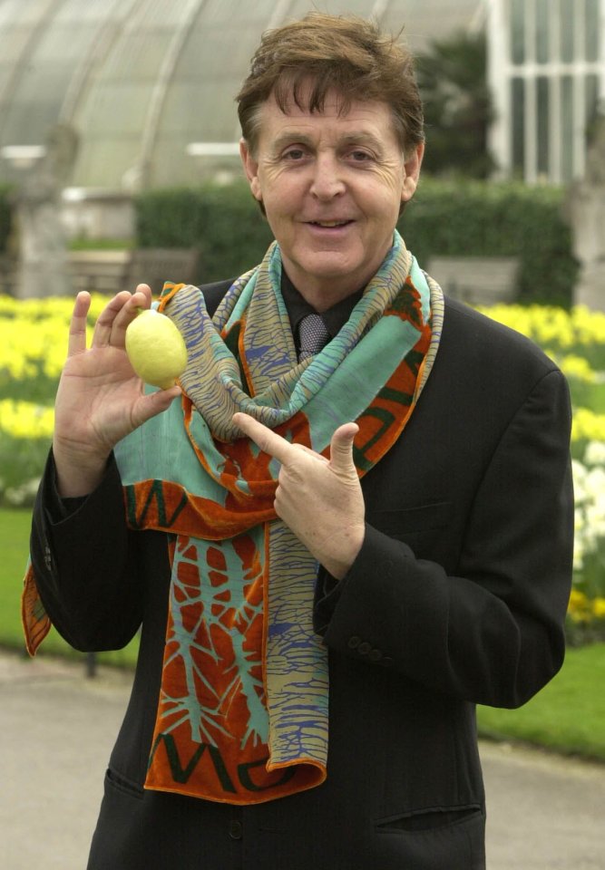 Paul McCartney holding a lemon at Kew Gardens.