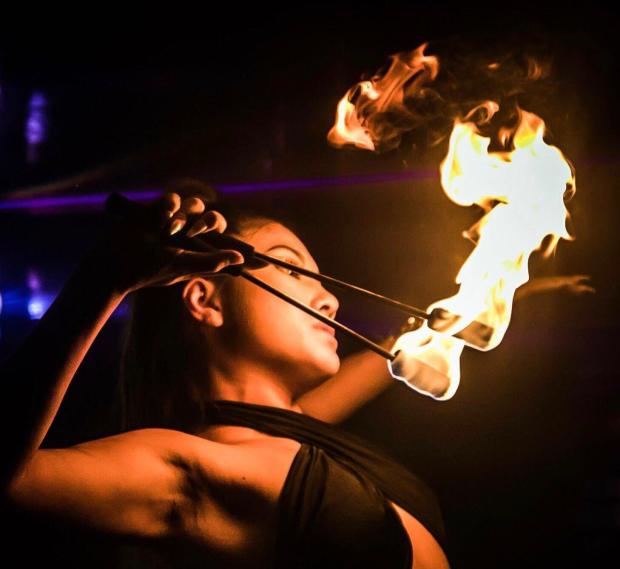 Woman performing fire dancing.