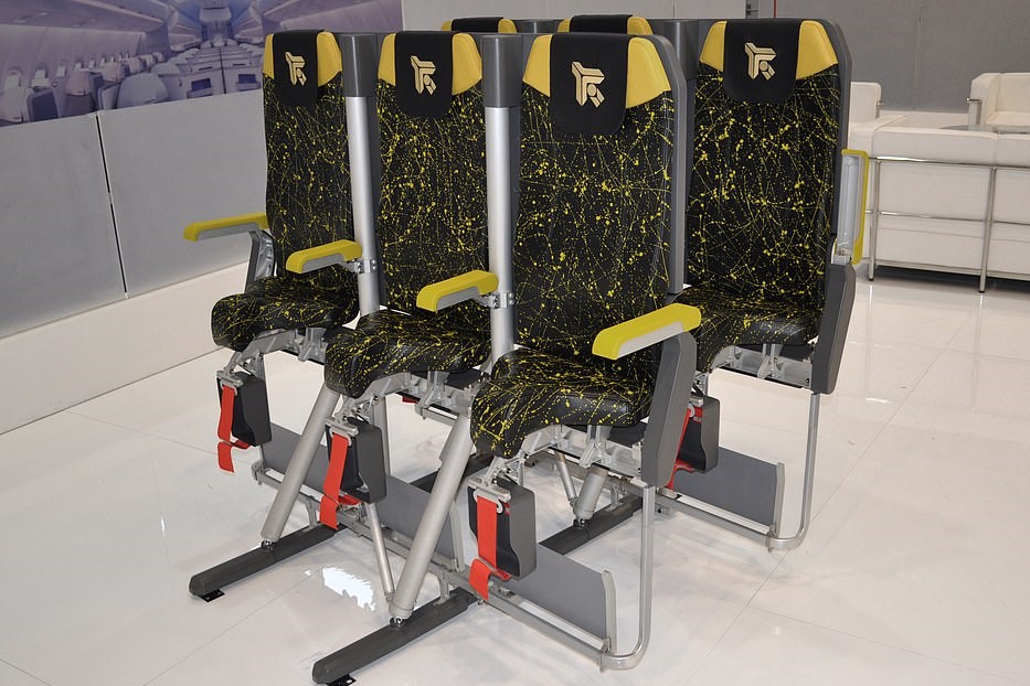 Four upright airplane seats designed to increase passenger capacity.