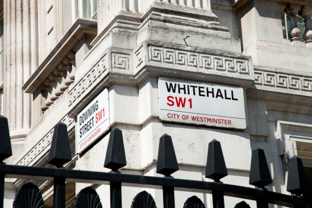 Street signs for Downing Street and Whitehall in London.