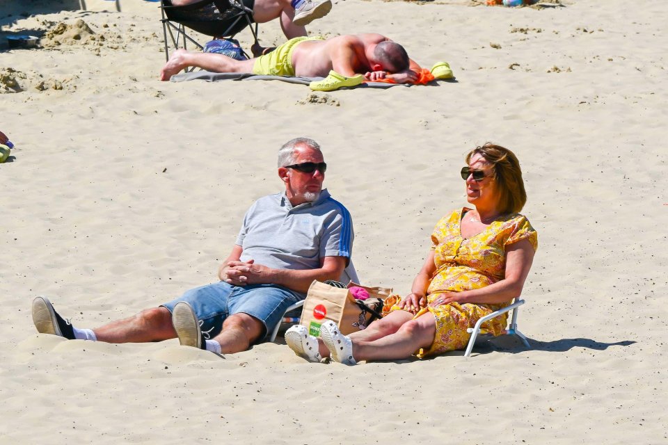 Couple relaxing on a sunny beach.