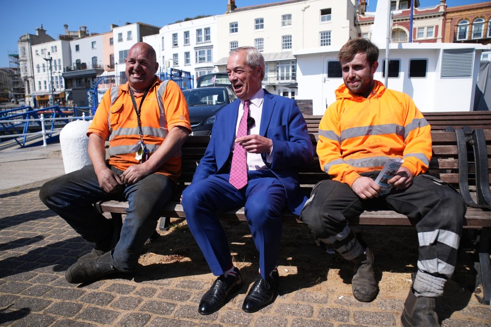 Nigel Farage with supporters on a park bench.