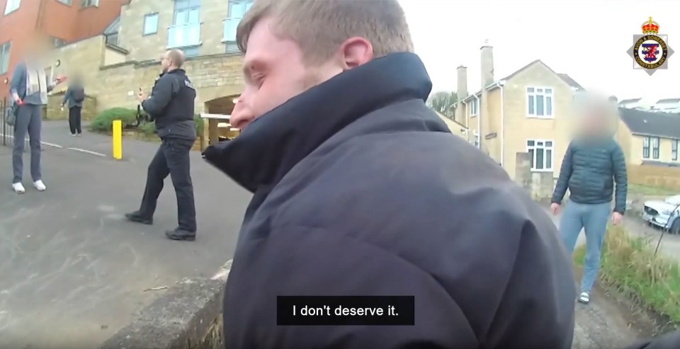 A man in custody says, "I don't deserve it."