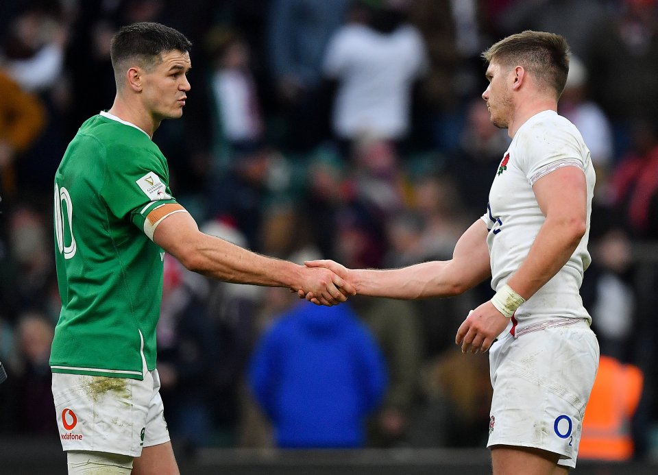 Jonathan Sexton and Owen Farrell shaking hands after a rugby match.