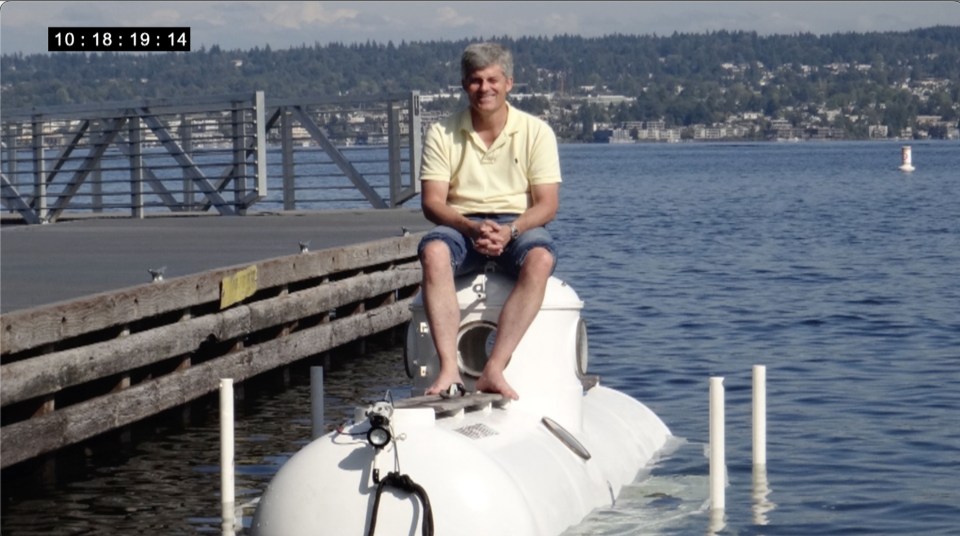 Submersible pilots communicating inside a submersible.