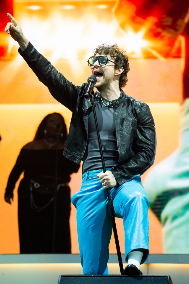 Tom Grennan performing at a concert.