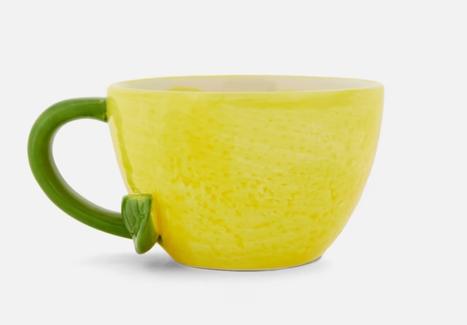 Lemon-shaped mug with green handle.