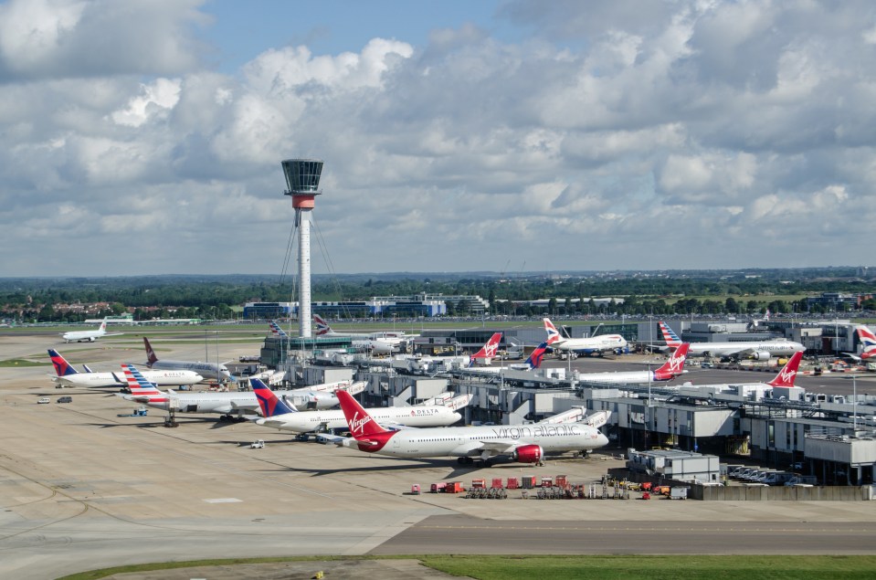 Aerial view of airplanes parked at an airport terminal.