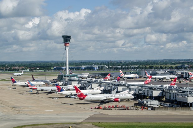 Aerial view of airplanes parked at an airport terminal.