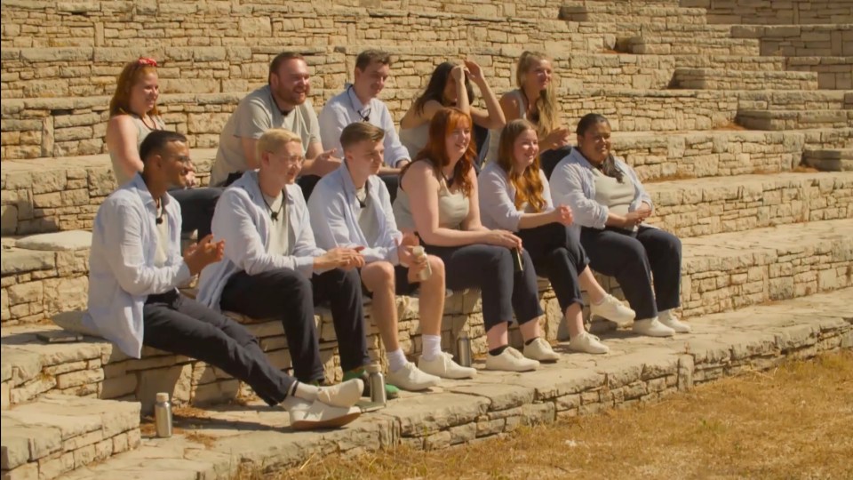 Group of people sitting on stone steps.