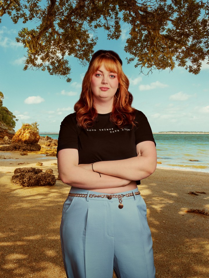 Woman standing on a beach.
