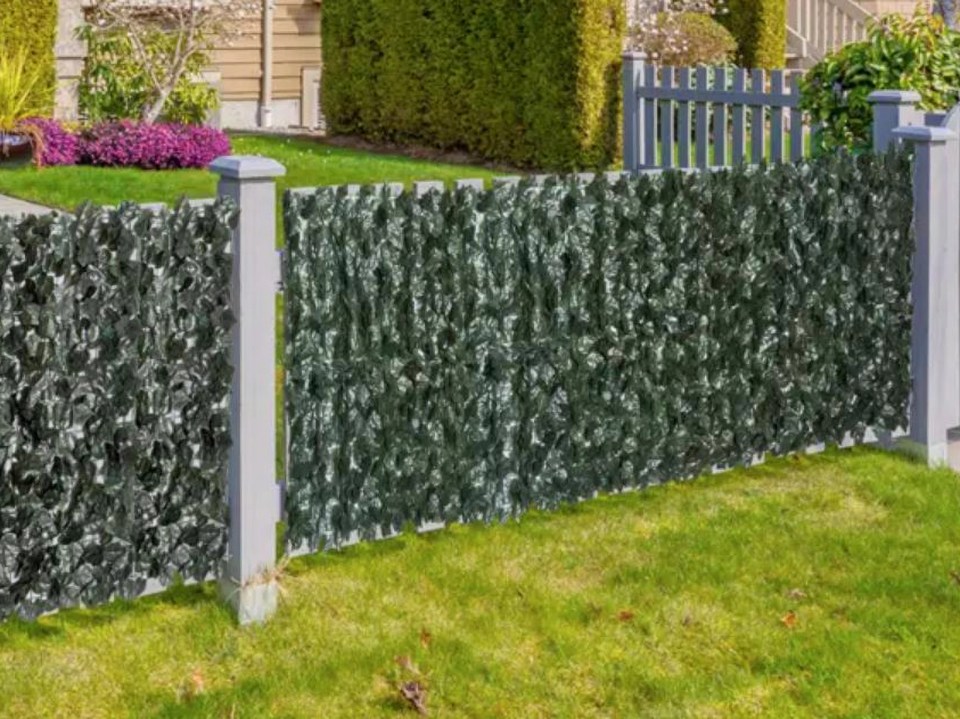 Artificial ivy privacy fence in a garden.